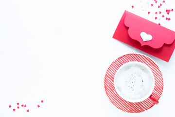 Red coffee cup and gift box on white table. Top view with copy space