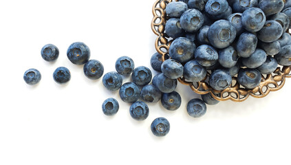 Fresh natural blueberries in a metal plate on a white background. Place for text. Flat lay.