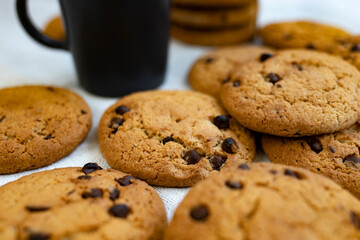 Homemade oatmeal cookies with chocolate drops close-up on the table. Side view.