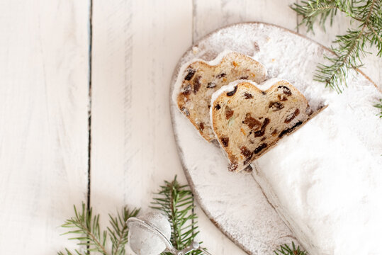 Christmas stollen on wooden background. Traditional Christmas festive pastry dessert. Stollen for Christmas