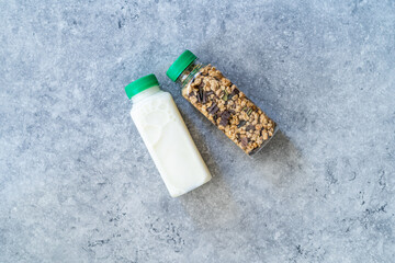 Roasted Granola in Plastic Bottle with Pumpkin Seeds, Chocolate Drops, Honey and Milk.