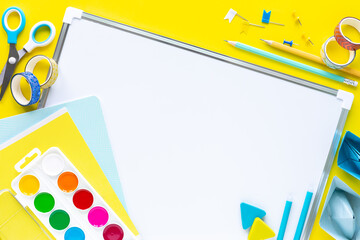 School colorful stationery on yellow background with copyspace