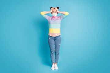 Full length photo of pretty shocked teen lady hold arms on head need pass session exams during quarantine wear protect face mask jeans striped pullover shoes isolated blue color background