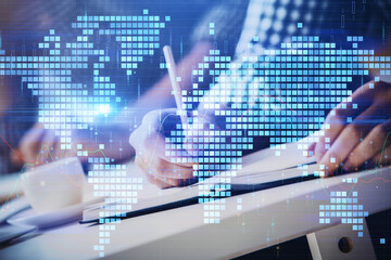 Double exposure of Man writing in notepad with business icons on background.