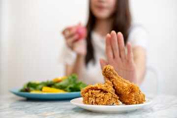 Dieting or good health concept. Young woman rejecting Junk food or unhealthy food such as fried...