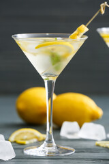 Glass of tasty martini cocktail on table