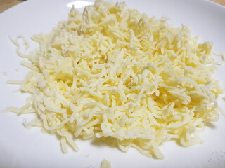 Shredded cheddar cheese portion for cooking recipe.

