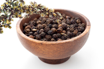 Thyme grains in white background and wooden presentation bowl