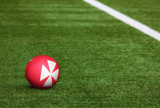 Wallis And Futuna flag on ball at soccer field background. National football theme on green grass. Sports competition concept. - Powered by Adobe