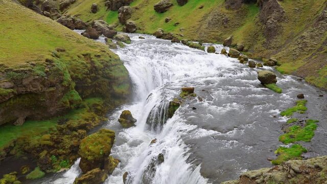 Nice morning view of waterfall on Skoga river. View from the tourist trek from famous Skogafoss waterfall to the top of the river, Iceland. Full HD Medium to Close up zoom in shot video (High Definiti