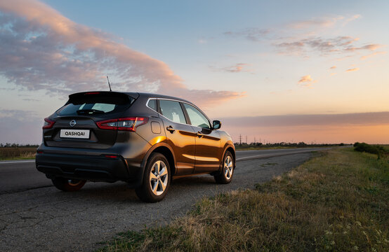 Ukraine - July 7, 2020: Nissan Qashqai on countryside road at sunset