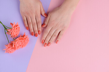 Coral pink nails and flowers. Bright color for a romantic person