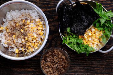 raw material ready to cook vegan Vietnamese simple meal for lunch, cold rice, yellow corn, seaweed, basil
