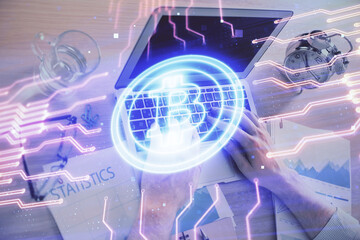 Blockchain theme hologram with man working on computer on background. Concept of crypto chain. Double exposure.