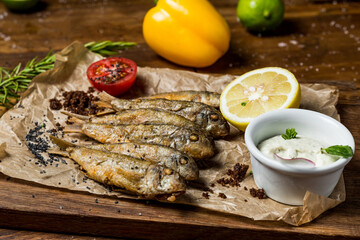 Fried red mullet with lemon and white sauce, restaurant serving