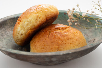 Fresh muffin in white background and old copper bowl