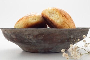 Fresh muffin in white background and old copper bowl