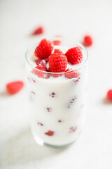 Milk with raspberry in the glass. Selective focus. Shallow depth of field.