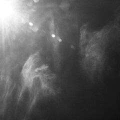 bright summer sun on a blue sky, black and white photo