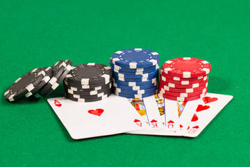 Royal Flush Playing Cards and Blue, Red and Black Casino Poker Chips. Pattern Isolated on Green Background Table.