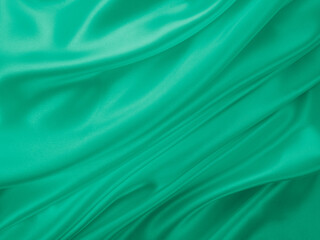 Beautiful elegant wavy light green satin silk luxury cloth fabric texture, abstract background design. Card or banner.