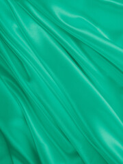 Beautiful elegant wavy light green satin silk luxury cloth fabric texture, abstract background design. Card or banner.