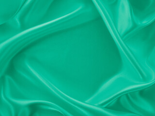 Beautiful elegant wavy light green satin silk luxury cloth fabric texture, abstract background design. Card or banner.