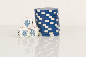 Blue Playing Casino Poker Chips and Queens Poker Dice. Isolated on white background with reflection. Abstract Pattern
