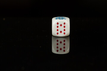Casino playing poker dice ten isolated on black background.