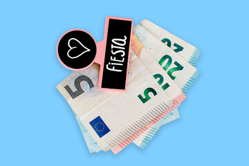 EUROPEAN BANKNOTES ON WHITE BACKGROUND TAKEN ON A PINK WOODEN CLAMP WITH SLATE AND TEXT