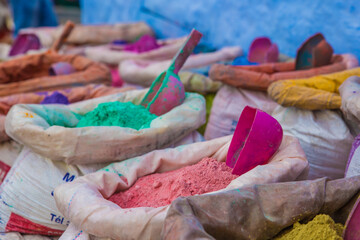 Stumbling upon the colourful assortment of powdered pigments that create a beautiful contrast with the coloured walls 
