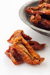 Dried tomatoes in aged copper bowl