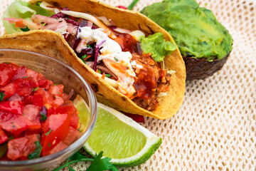 Mexican traditional authentic homemade tacos with pulled pork beef chili con carne serve with tomato salad and avocado guacamole and dip sauce