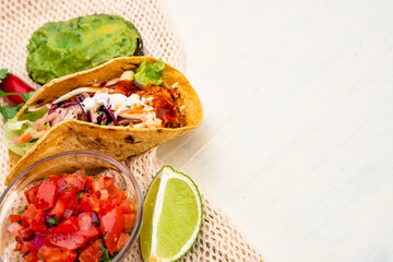Mexican traditional authentic homemade tacos with pulled pork beef chili con carne serve with tomato salad and avocado guacamole and dip sauce