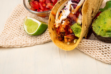 Mexican traditional authentic homemade tacos with pulled pork beef chili con carne serve with tomato salad and avocado guacamole and dip sauce