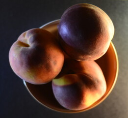 peaches close-up in a file on a dark background top view