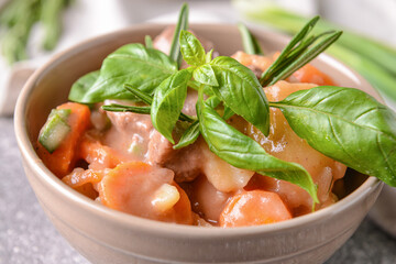 Bowl with tasty beef stew on table, closeup