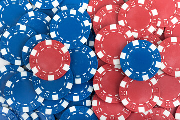 Battle Blue versus Red yin vs yang Playing Poker Chips laying on the table mixed together. Abstract Pattern Background