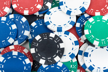 Playing Poker Chips laying on the table mixed together. Abstract Pattern Background