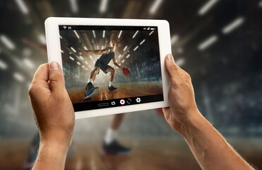 Close up hands holding tablet viewing sport, basketball online streaming of championship. New rules...
