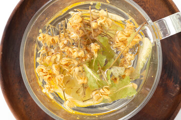 Herbal tea in a glass cup on a white background