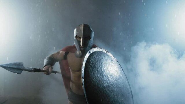 Muscular spartan fighting with spear.