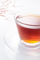 Black tea in a glass cup on a white background