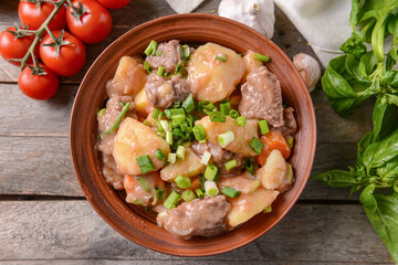 Bowl with tasty beef stew on table