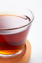 Black tea in a glass cup on a white background