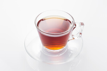 Black tea in a glass cup on a white background