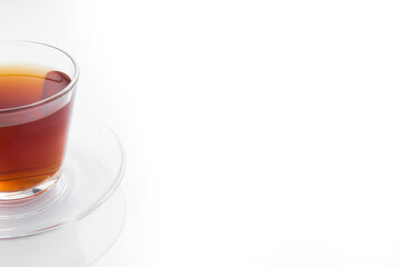 Black tea in a glass cup on a white background