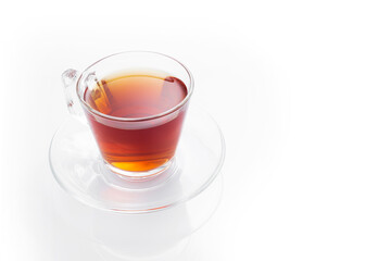 Black tea in a glass cup on a white background
