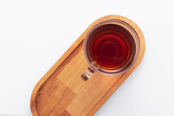 Black tea in a glass cup on a white background