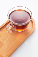 Black tea in a glass cup on a white background